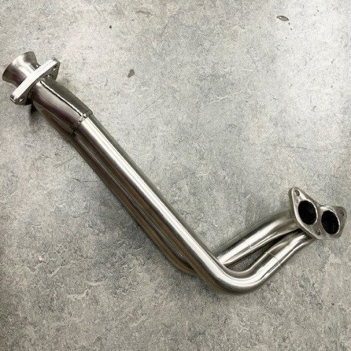 Twin connecting pipe left hand +8 5 speed to 1987