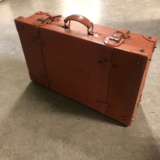 Brown suitcase. There is currently a long delay on this part.